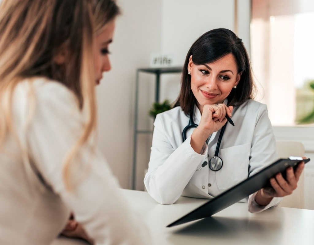 Female doctor reviewing information with a patient during a consultation.